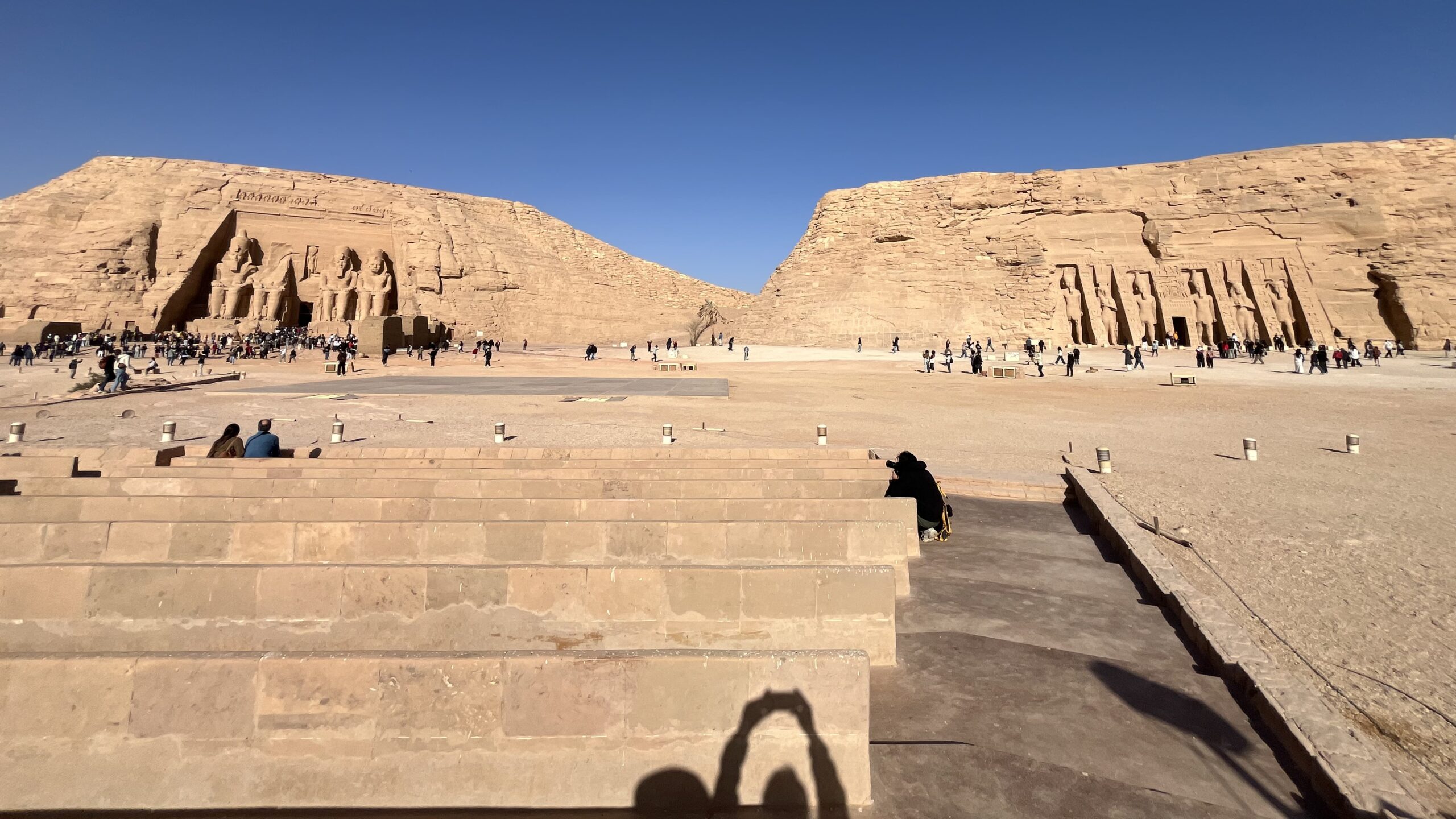 Aswan Abu Simbel Travel Guide : A panoramic view of the Great Temple of Ramesses II and the Small Temple of Nefertari as seen from the waters of Lake Nasser.