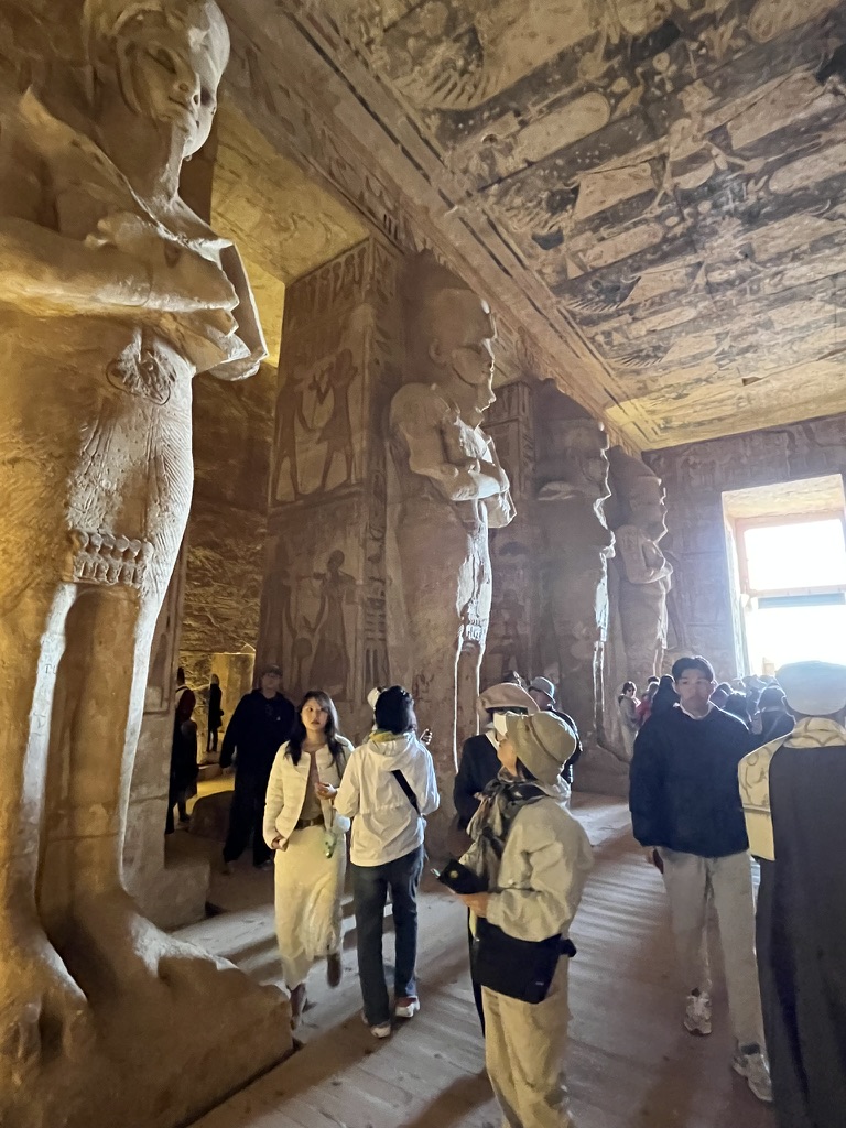 Looking down the central aisle of the first hall, lined with eight massive pillars carved into the shape of the god Osiris, bearing the features of Ramesses II.