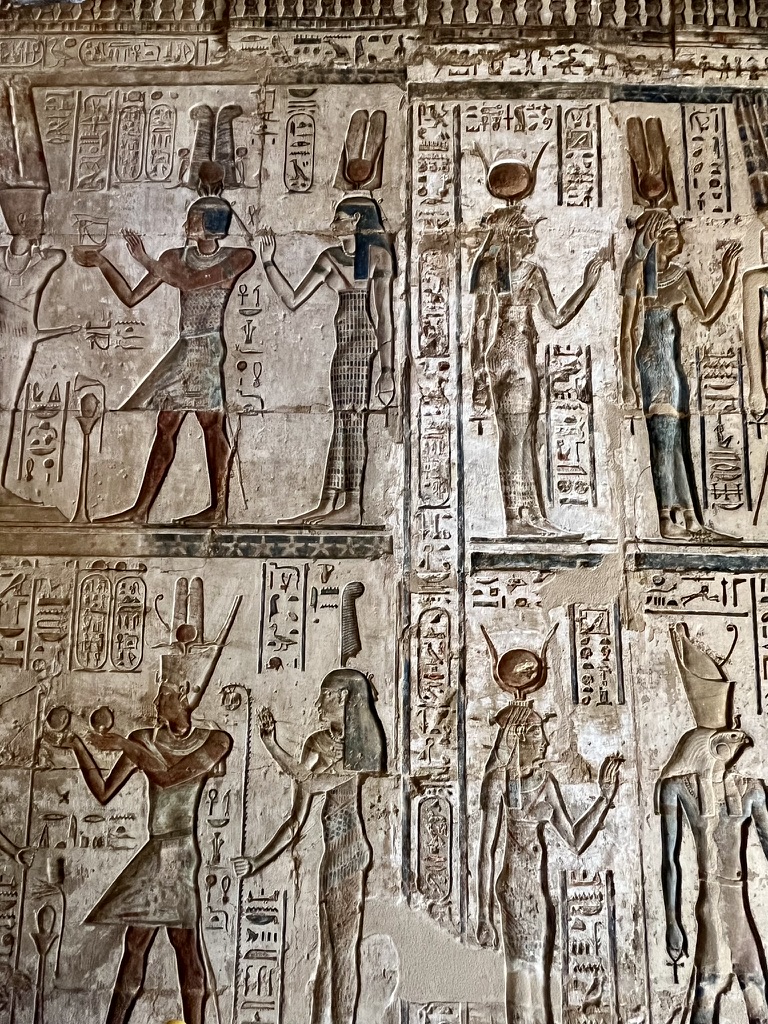 Burial chamber wall, Deir el-Medina - Registers of finely painted reliefs depicting the Pharaoh or a high-ranking artisan making offerings to a row of seated deities in the presence of the goddess Maat and Horus.