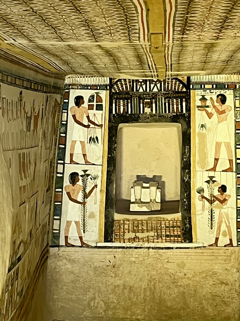 A highly detailed register showing workers preparing baskets of fruit, grain, and floral arrangements to be presented as offerings for the afterlife.