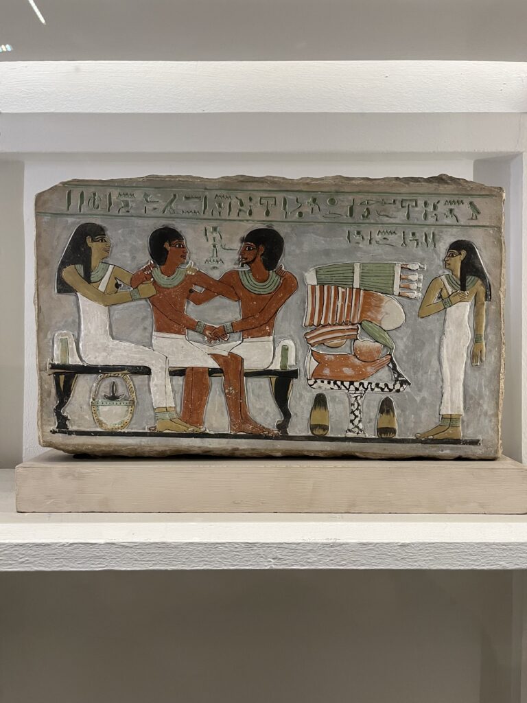 An intricate limestone relief captures a vibrant funerary offering table, where carved images of fruit, beer jars, and lotus flowers were believed to sustain the life force, or ka, of the deceased in the afterlife.