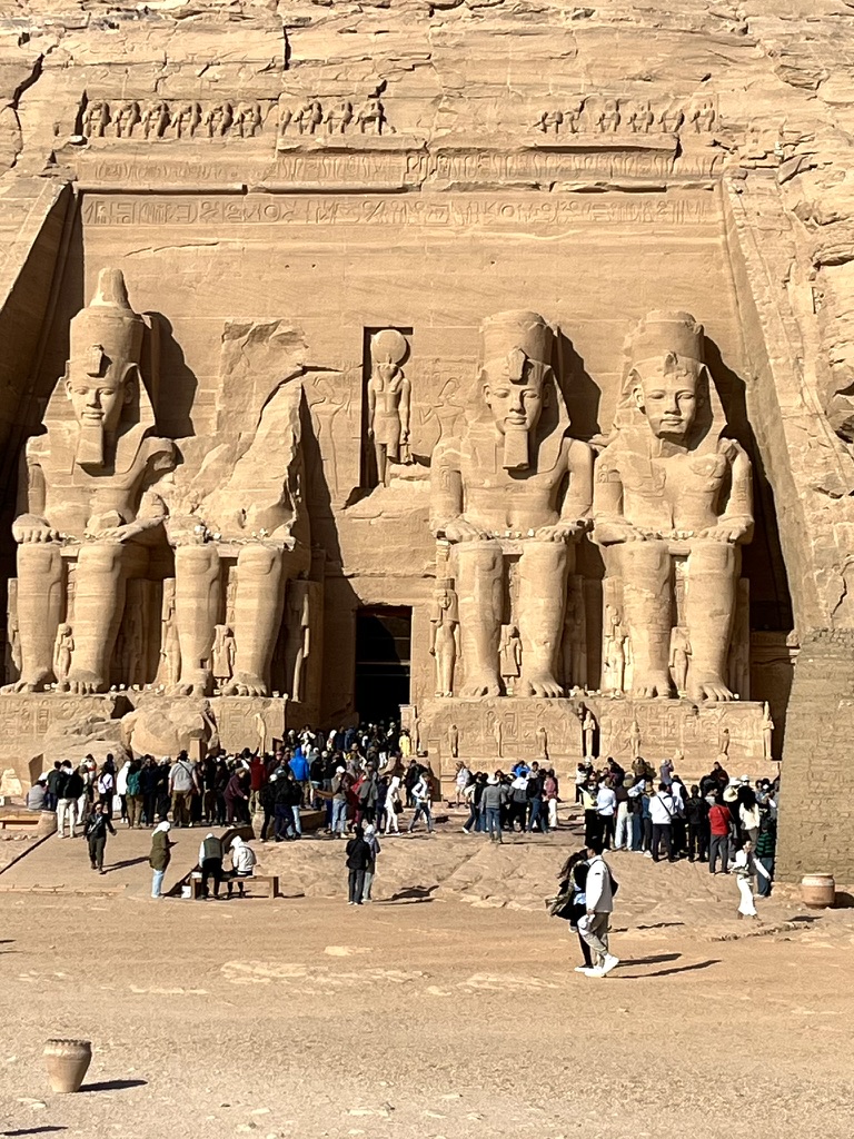 The facade of the Great Temple of Ramesses II at Abu Simbel, featuring four colossal seated statues of the Pharaoh.