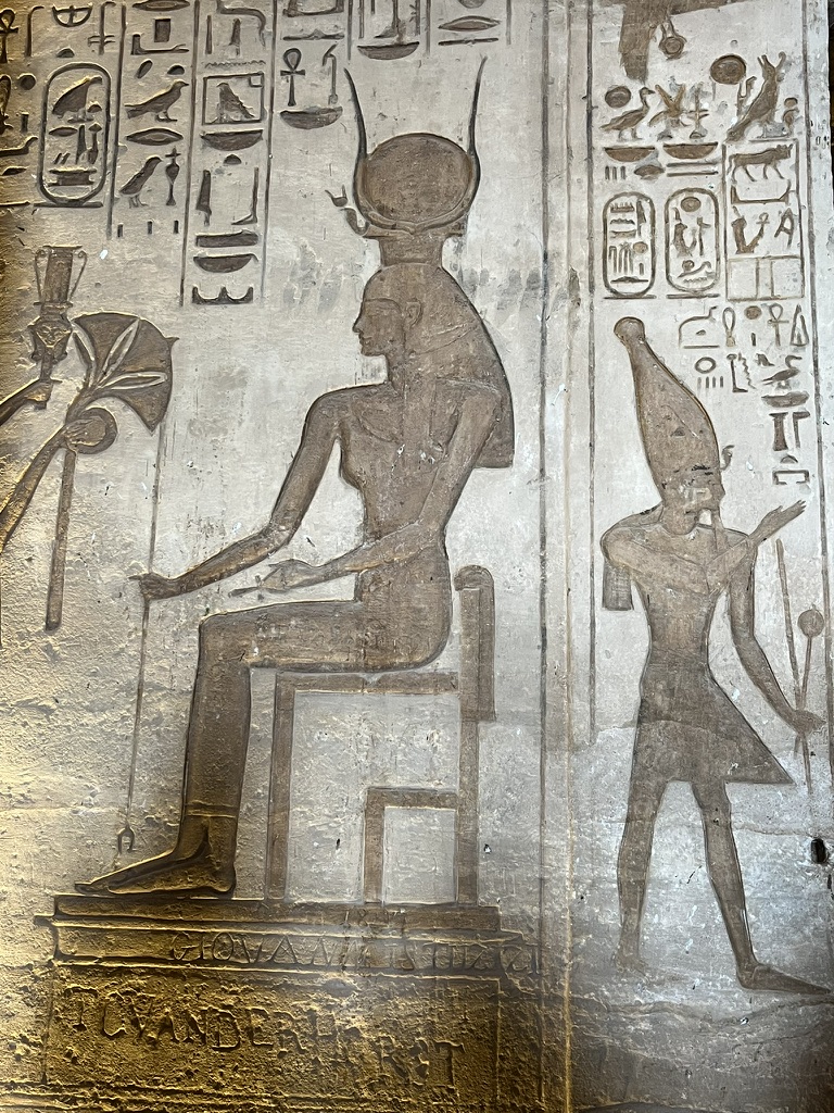 Looking down the central aisle of the first hall, where six square pillars are decorated with the "Sistrum" face of the cow-eared goddess Hathor.