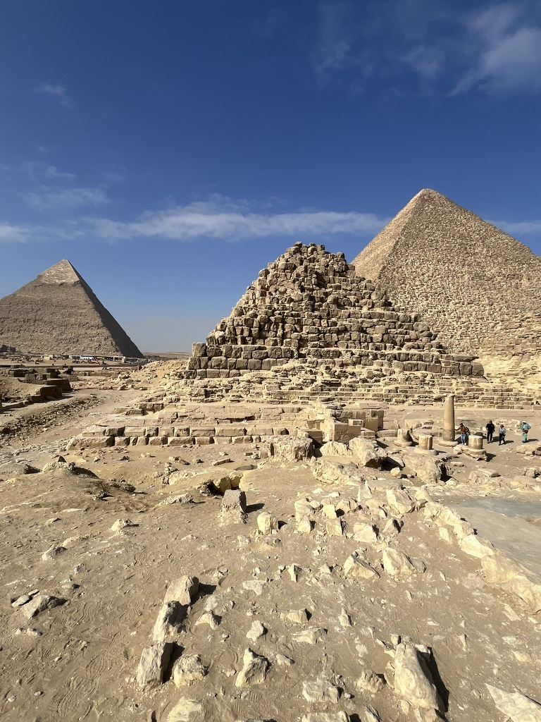 Situated on the edge of the Sahara Desert, the Giza Plateau features the three iconic Great Pyramids and the Sphinx, showcasing the massive limestone block construction that have endured for over 4,500 years.