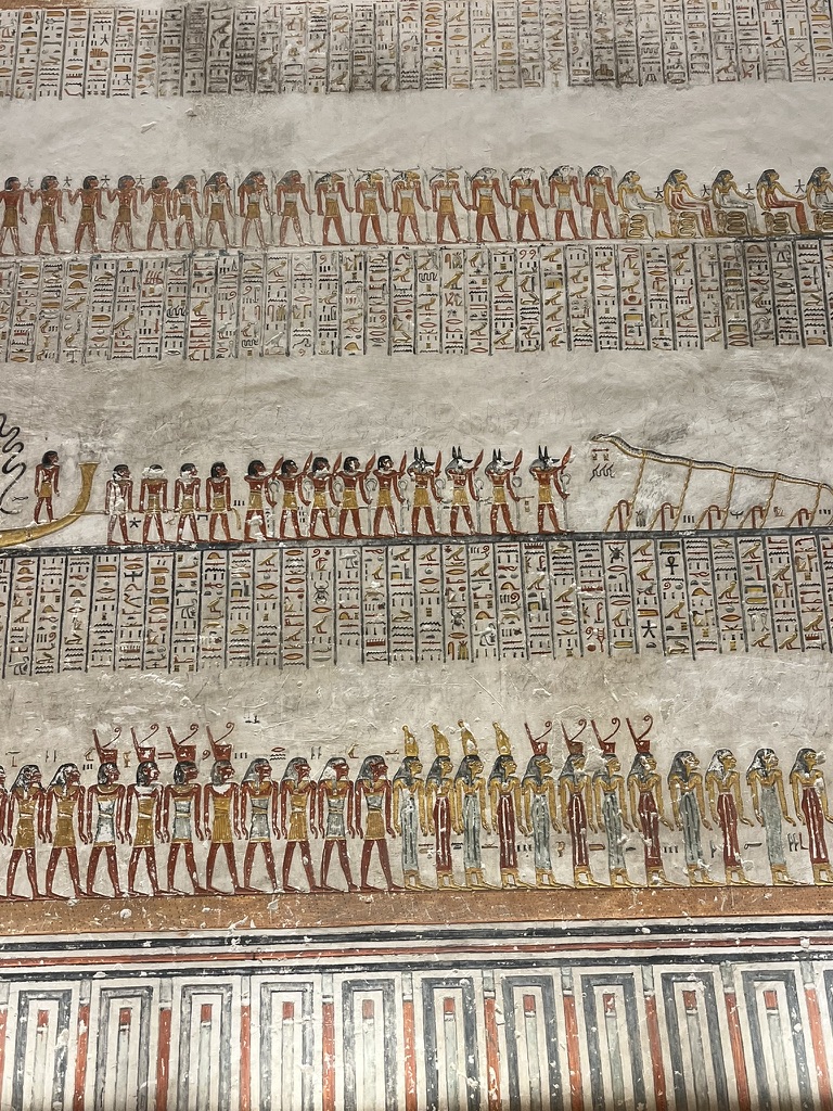 A perspective looking down a corridor of the KV9 tomb at Valley of the Kings, with scenes from Book of Gates and the Book of Caverns.