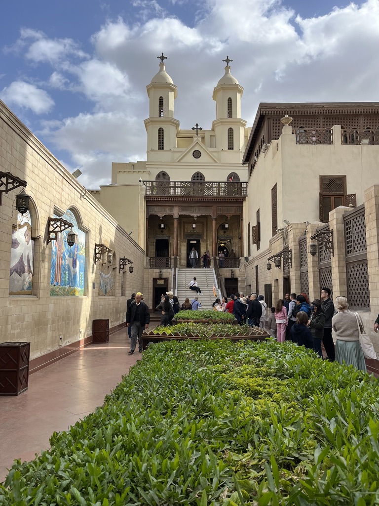 Looking toward the iconic twin bell towers of the "Hanging Church," one of Egypt's oldest and most famous religious sites, built atop the gatehouse of the Roman Babylon Fortress.