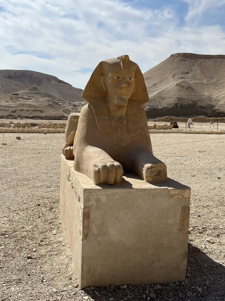 A limestone sphinx representing Queen Hatshepsut with the traditional nemes headdress and a ceremonial beard, symbolic of her role as a pharaoh.