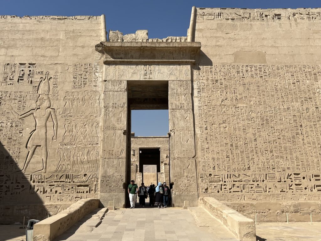 The monumental High Gate (Migdol), which serves as the unique fortress-style entrance to the Mortuary Temple of Ramesses III.