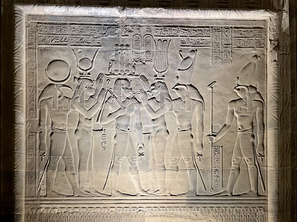 A detailed relief depicting what are believed to be some of the world's earliest surgical instruments, including scalpels, bone saws, forceps, and dental tools.