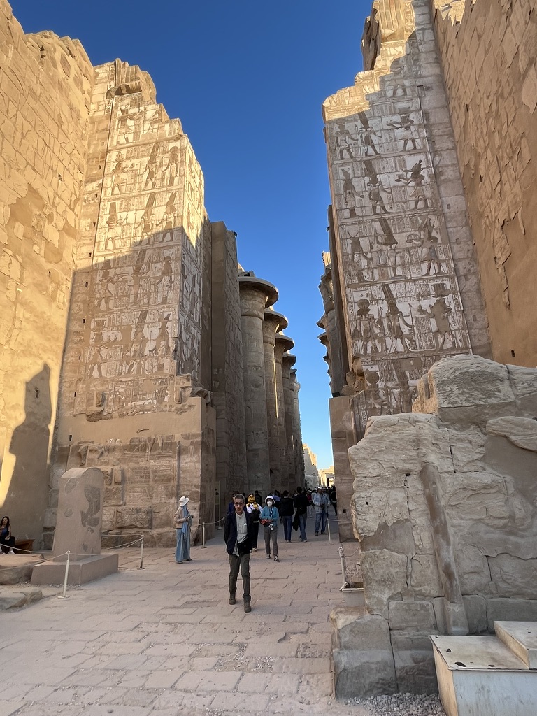 The towering gateway of the Second Pylon, decorated with monumental reliefs of the Pharaoh making offerings to the gods, captured during the late afternoon.