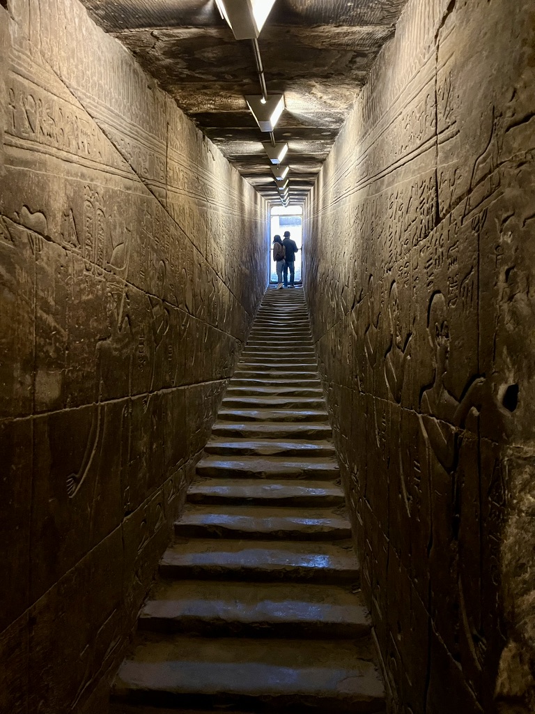 The innermost Sanctuary of Horus, featuring a dark granite monolithic shrine and a modern replica of the Sacred Bark (processional boat).