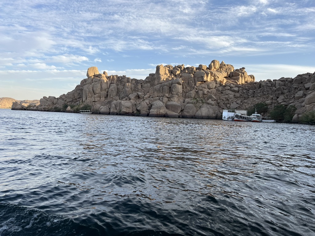 A wide view of Agilkia Island, the current home of the Philae Temple complex, as seen from an approaching boat.