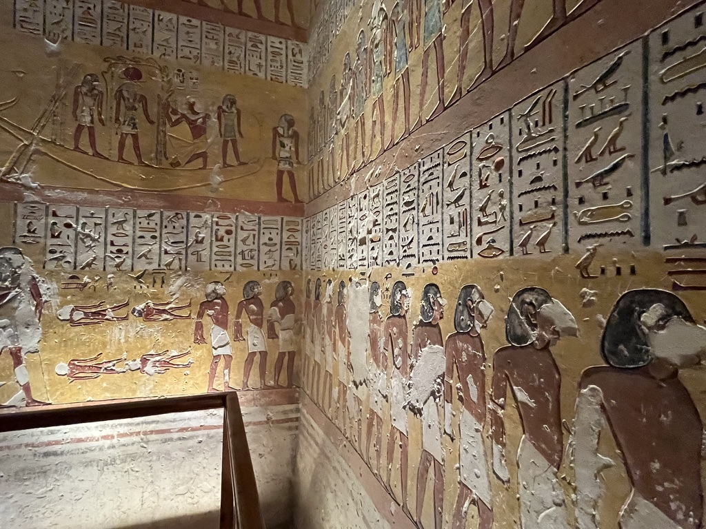 Elaborate wall reliefs showing horizontal registers of figures and hieroglyphics that detail the "Litany of Ra" and scenes from the Book of Gates.