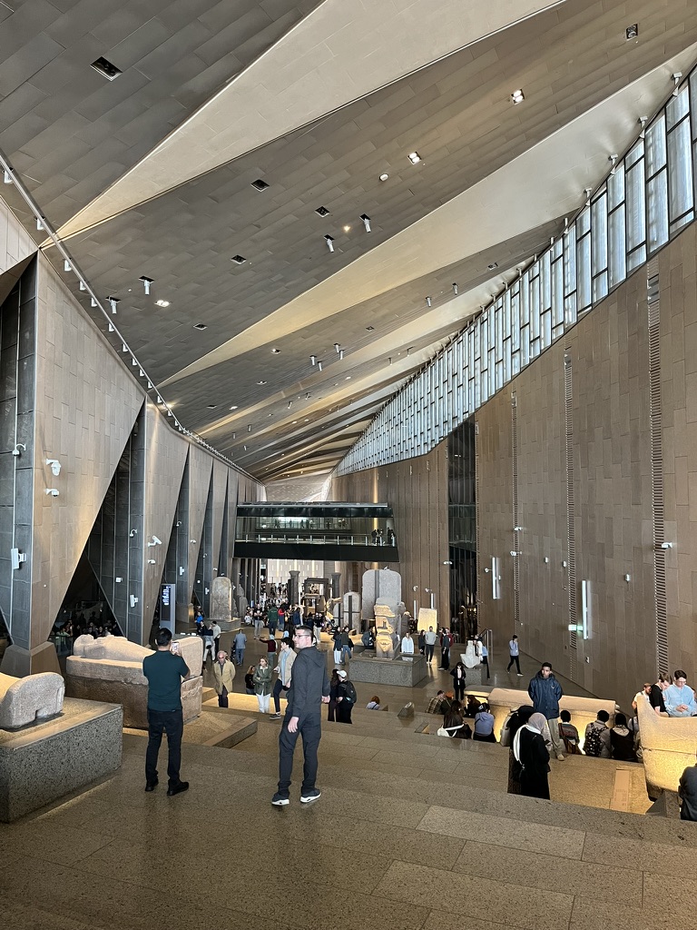 The Grand Staircase is a soaring vertical gallery that leads visitors upward past dozens of colossi and sarcophagi.