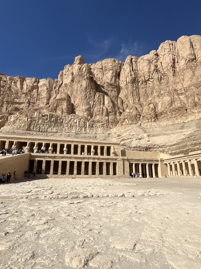 The terraced Mortuary Temple of Hatshepsut rises against the golden cliffs of Deir el-Bahari.