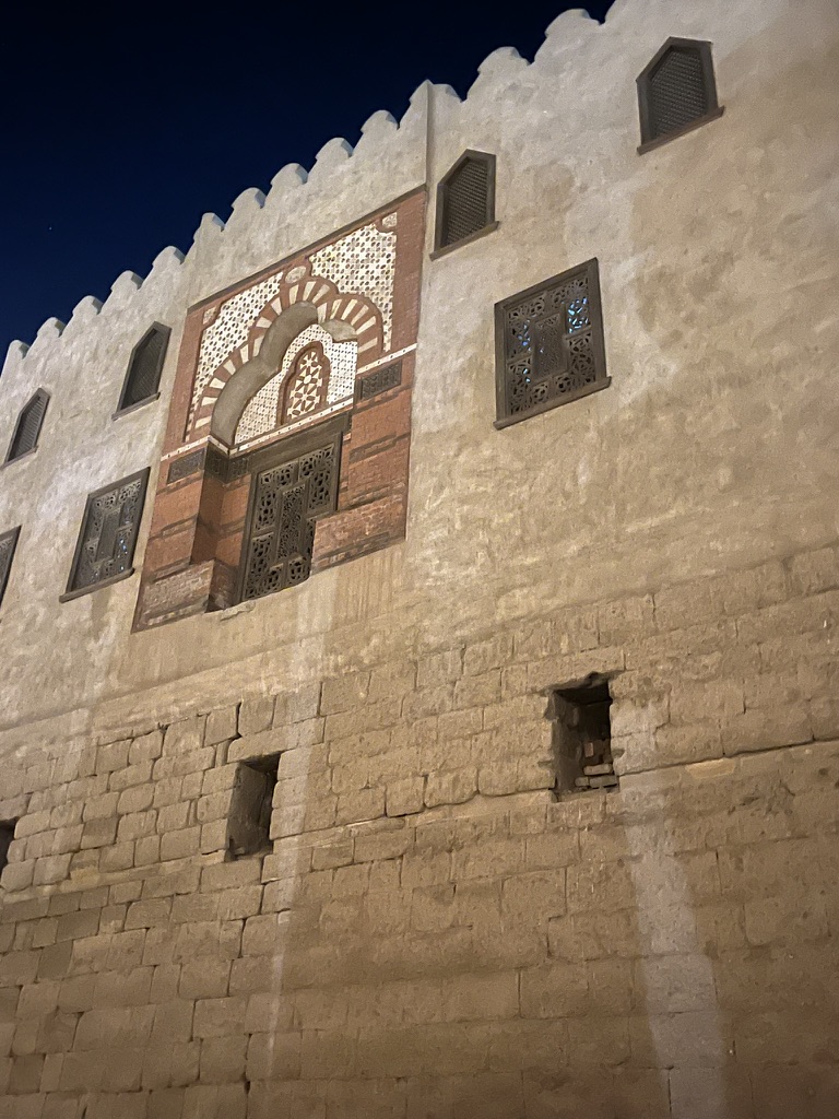 The exterior walls and decorative windows of the Mosque of Abu al-Haggag, which was constructed over the ancient Egyptian temple structure during the Ayyubid period.