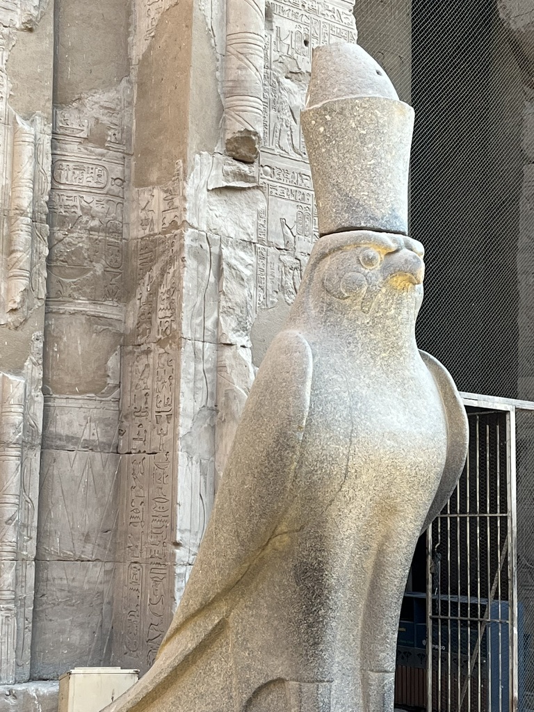 Large granite statue of the falcon god Horus wearing the double crown of Egypt at the Temple of Edfu.